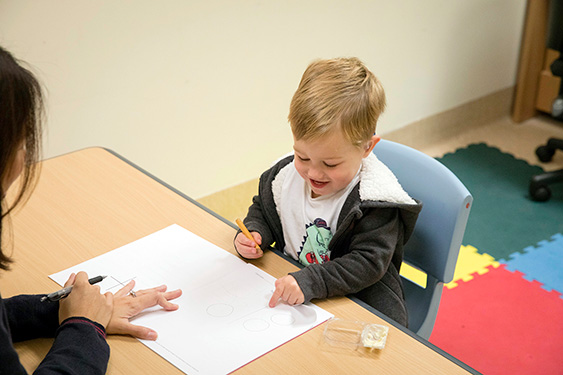 A child drawing on a piece of paper