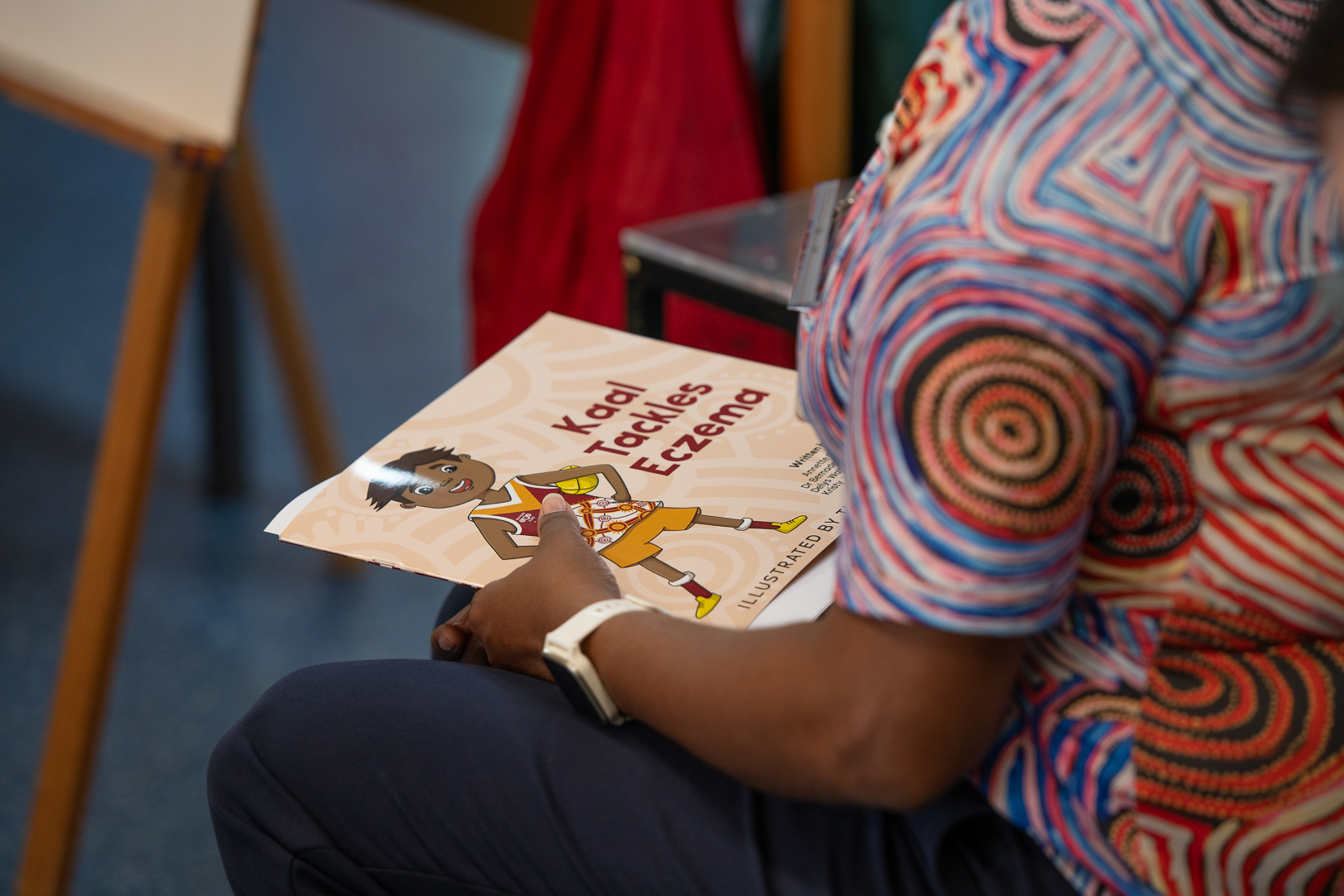 person holding the kaal tackles eczema book