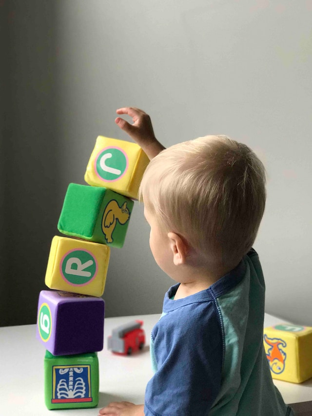 A child stacking blocks