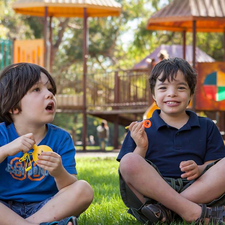 Two children sitting in a playground